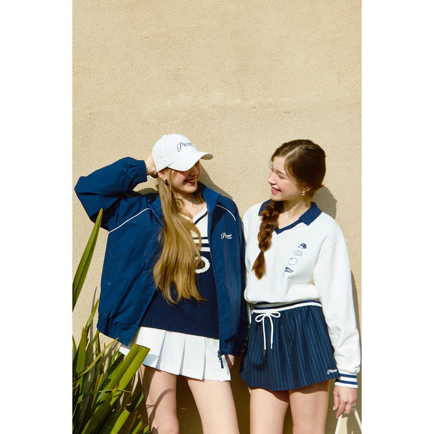 two models wearing stylish outfits, featuring the piv'vee v neck golf sweatshirt in a trendy ensemble
